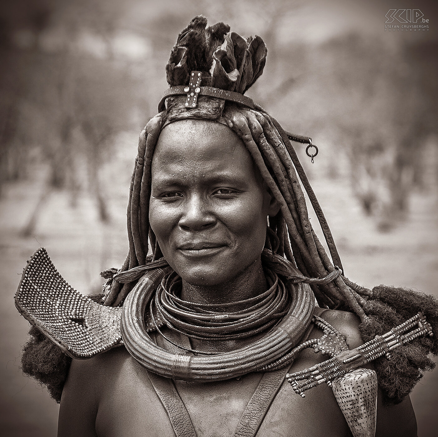 Omangete - Himba woman One of the older Himba women of the village who apparently was one of the chiefs. The Himba women are famous for covering their hair and body with otjize (mixture of fat and ochre). Married Himba women wear headdresses with many streams of braided hair and a kind of turban made of goat leather and necklaces adorned with shells and jewellery made of iron and copper.<br />
 Stefan Cruysberghs